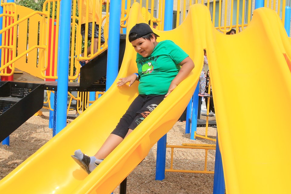 Kids of all ages were eager on Wednesday, Aug. 21, 2024 to test out Matawa Awashishewiigiihiwaywiin's new playground structure. (Leith Dunick, tbnewswatch.com)