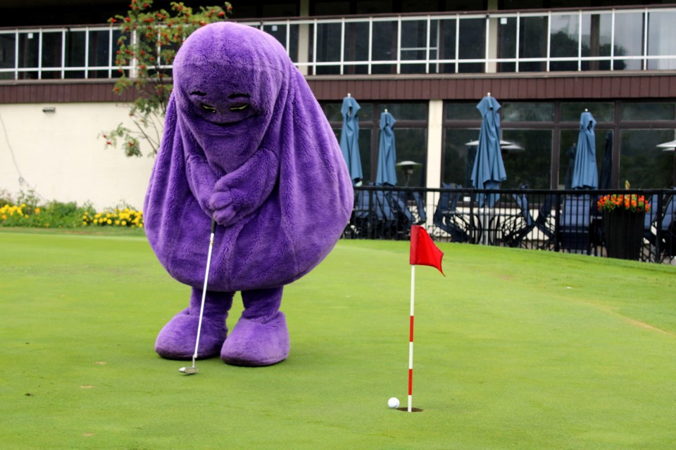 Grimace tests out his putting skills at the Fort William Country Club during the 2024 Ronald McDonald House Charity Golf Tournament.