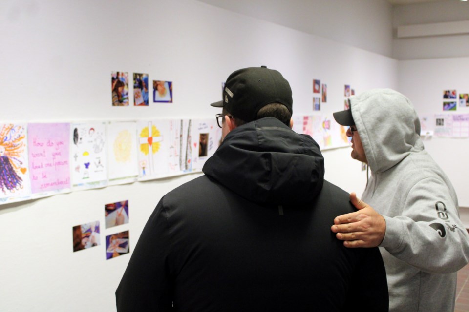 Patrons at the Thunder Bay Art Gallery look at one of the exhibits at Breaking Through the Shadows: Voices of Change in the Community, which runs at the gallery through Jan. 5.