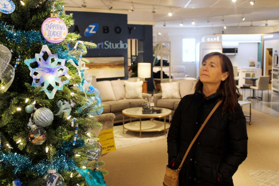 Colleen Dolce looks at the PRO Kids tree that is up for bids as part of Reid’s Furniture charity Christmas tree auction.