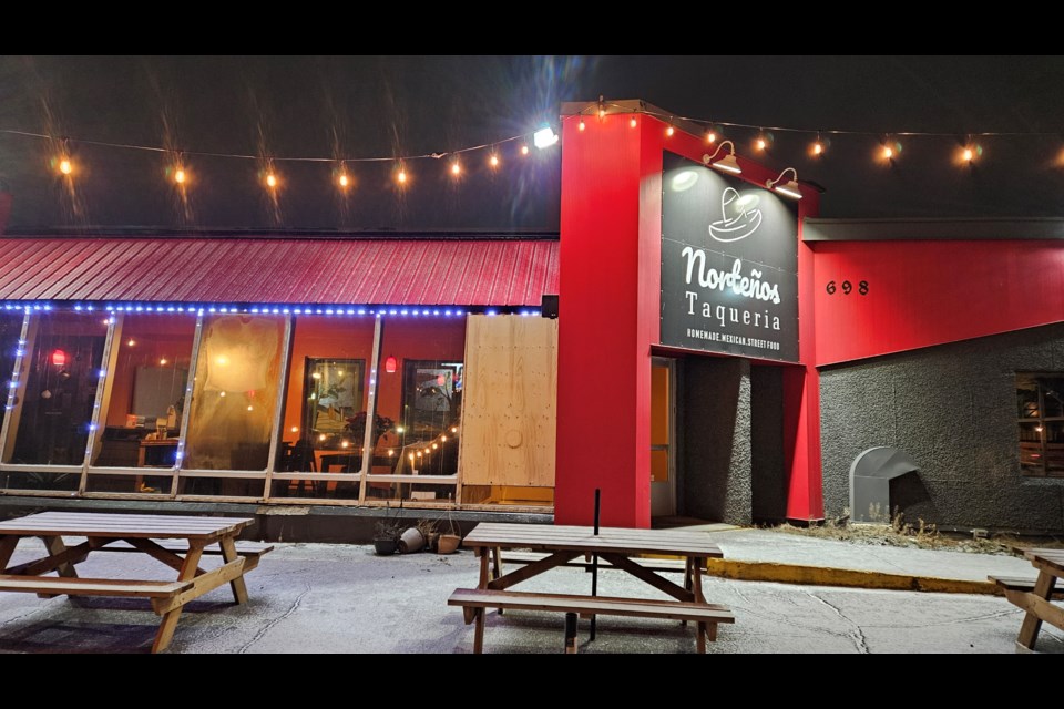 A wooden panel covers the window of Norteños Taqueria that was broken during a break-and-enter incident on the morning of Jan. 11.