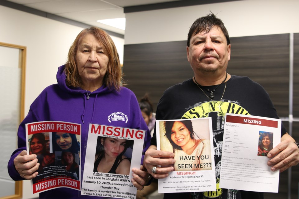 Mary Waboose, her grandmother, and father, Vernon Shebagabow, left to right, show flyers of missing Adrienne Towegishig on Jan. 23. 