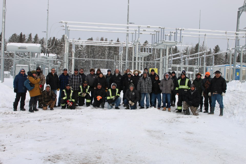 Poplar Hill First Nation residents meet outside its new Substation S on Jan. 29.