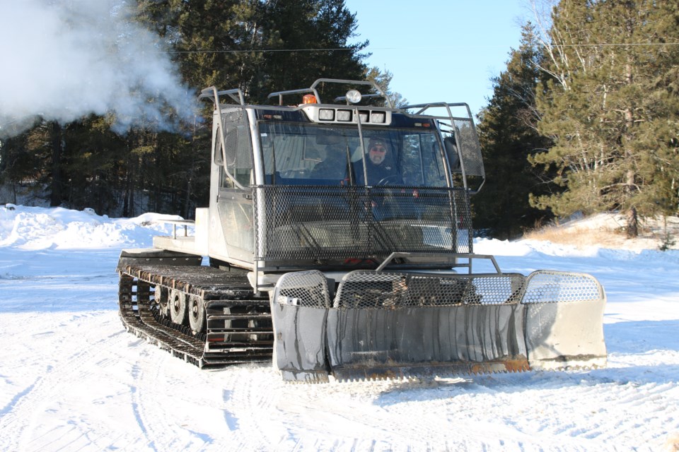 Adrian Tessier, the president of the Thunder Bay Adventure Trails Snowmobile Club, drives one of the club's snow groomers on Jan. 20.