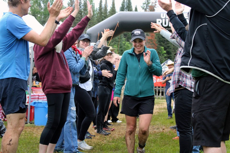 Emma Costa receives a round of applause after completing her 51st and final lap of the High Noon 24 Hour Trail Race and Relay on Sunday morning.