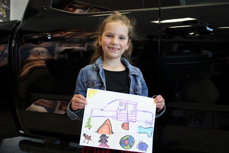 Elena Glavish poses with her drawing that was one of the winners in the Toyota Canada Dream Car Art Contest.