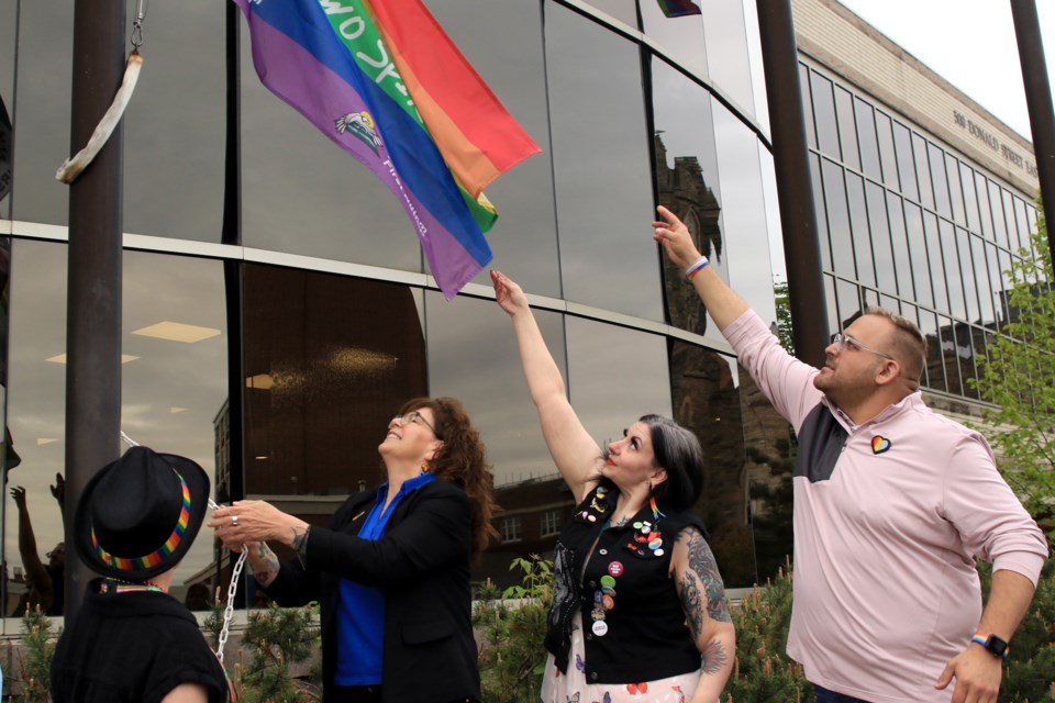 Fort William First Nation Chief Michele Solomon, Thunder Pride's Scotia Kauppi and Rainbow Collective's Jason Veltri raise the Two Spirit Pride Flag outside of city hall on Friday, May 31, 2024. (Leith Dunick, tbnewswatch.com)