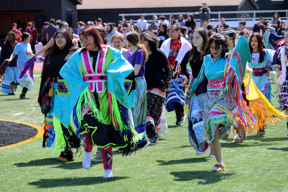 Students dance along to a song during the a powwow at St. Ignatius High School on Tuesday.