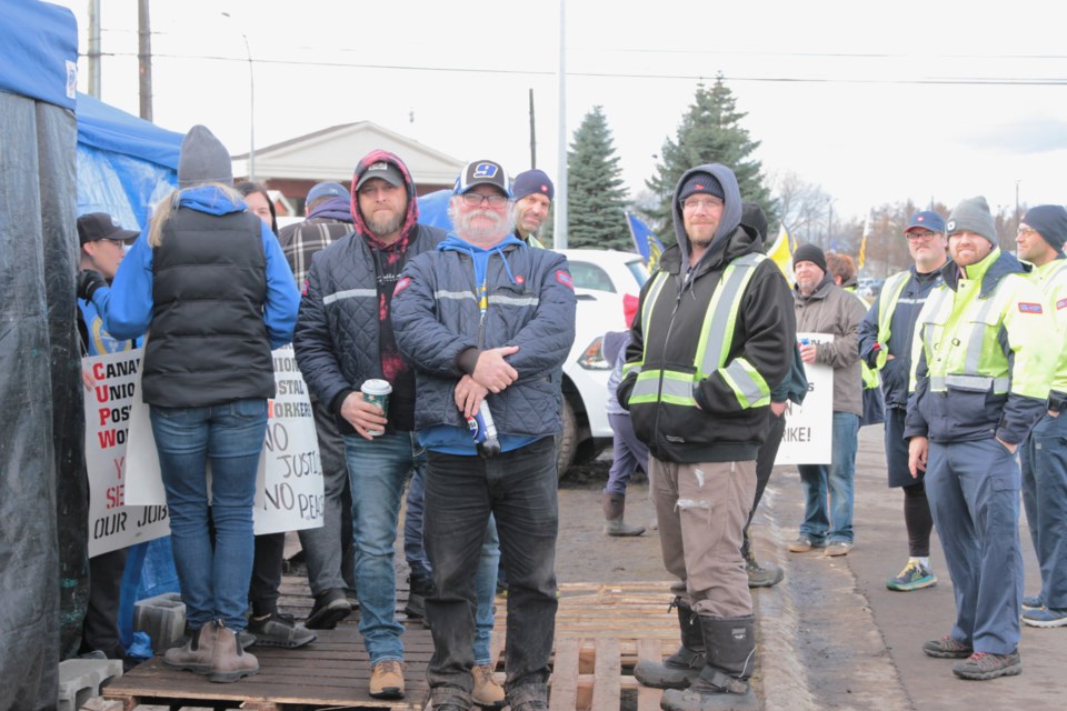 CUPW Local 620 president Leo Favreau and colleagues stake on guard for fair wages outside the Canada Post building  at 1005 Alloy Drive.