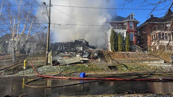 Firefighters continued to mop up hot spots on Dec. 2 at the scene of a devastating house fire on Crown Street the previous day (Olivia Browning/Newswatch)