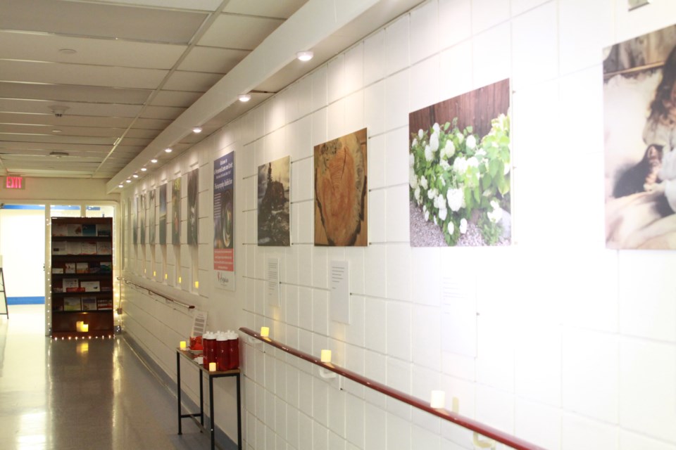 Walls lined with photos representing grief journey