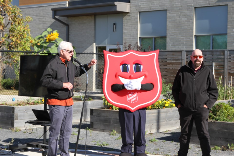 Port Arthur Rotary President David Legge and executive director for Salvation Army’s Journey to Life Centre Gary Ferguson celebration this year healing garden harvest.