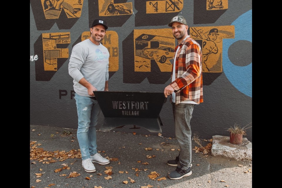 Jarret Popowich (l) and Matt Popowich display the now-recovered fire pit belonging to the Westfort Village Association (submitted photo)