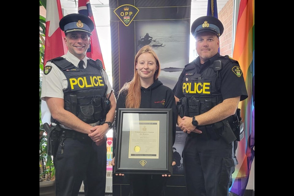 Caitlain McInnes (c) received the OPP Commissioner's Citation for Bravery on behalf of her late father, Allan McInnes (OPP photo)