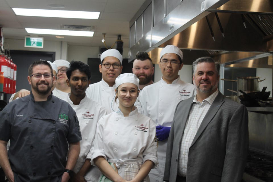 Tanner Harris (far left), Richard Gemmill (far right), with culinary students at Confederation College