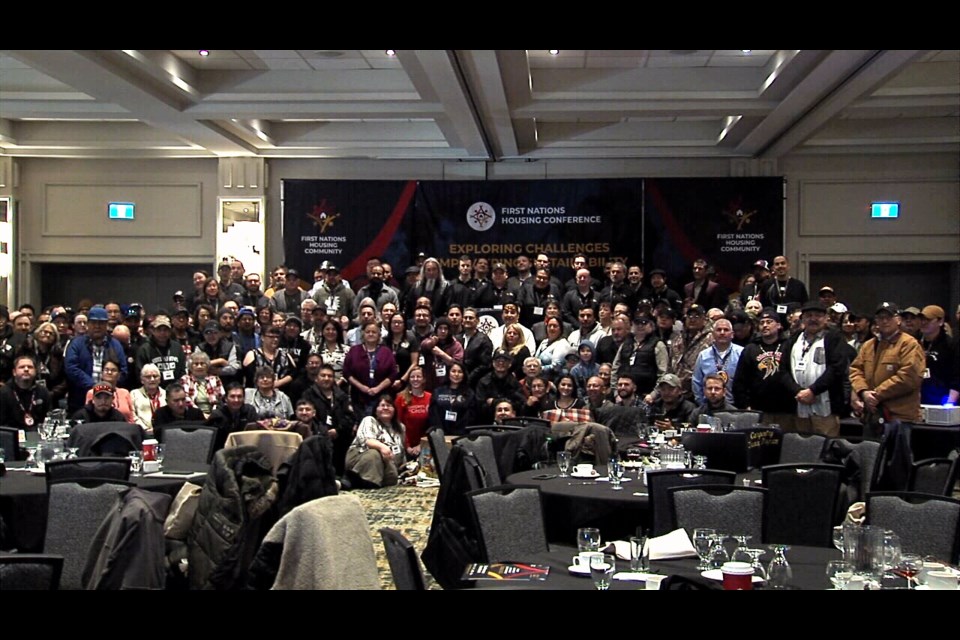 A group photo of delegates at the 2025 First Nations Housing Conference taken after Tuesday morning's opening ceremonies.