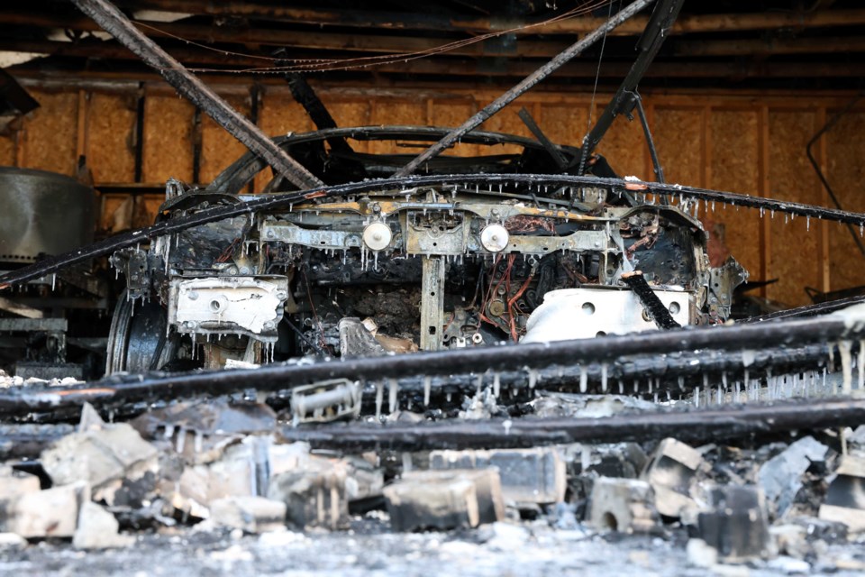 A fire destroyed this hybrid-electric vehicle and severely damaged a detached garage on the evening of Jan. 6, 2025.