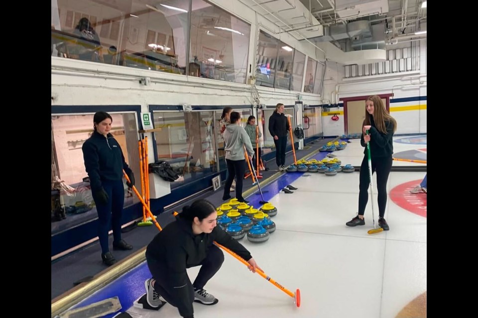 Members of the Lakehead University Women in Sport Association take to the ice at the Fort William Curling Club.