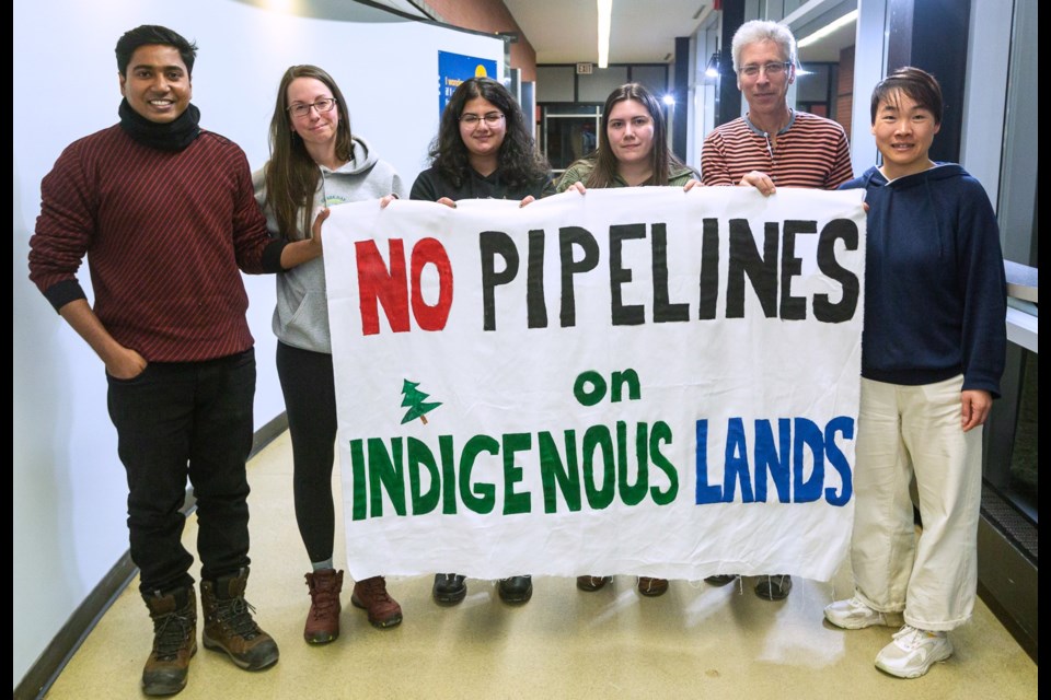 Lakehead University students hold a film screening and create a banner to raise awareness about Indigenous resistance to pipeline projects financed by Canadian banks on March 20. (Submitted by)