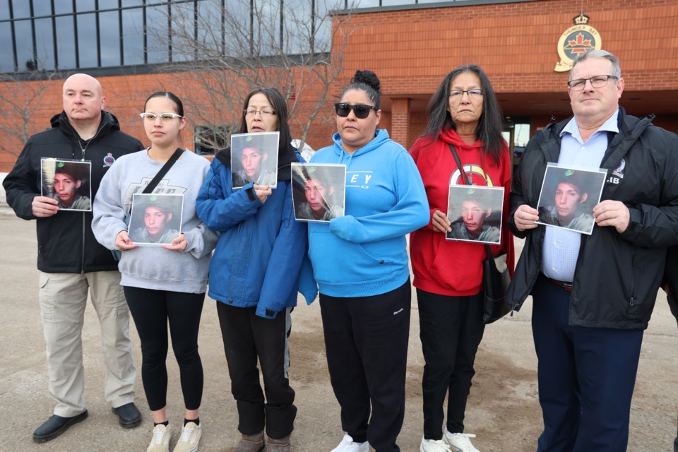 Family of Randall Jack show pictures of the missing man alongside Thunder Bay police investigators on March 12, 2025.