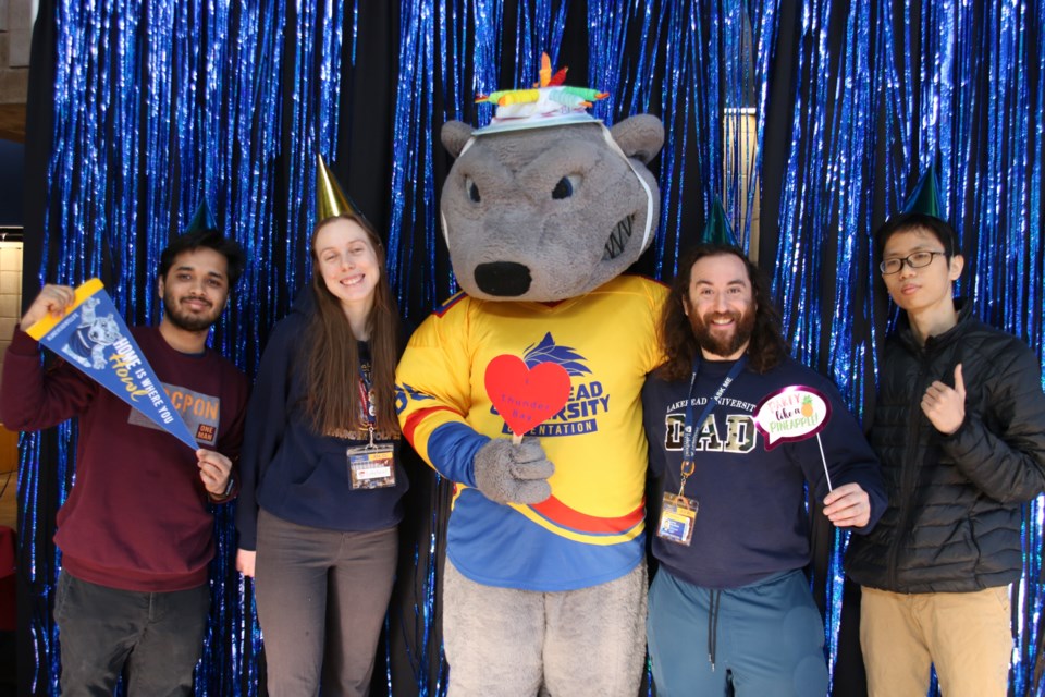 Lakehead University staff stood alongside the institution's mascot, Wolfie, at his 24th birthday celebration on March 20.