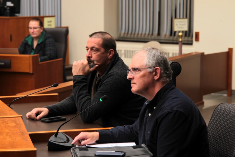 Woodside Parkette advocates, Kevin Green and Patrick Slavinski, persuade council to defer the sale of Woodside Parkette to allow residents to beautify the greenspace.