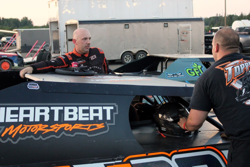 John Toppozini chats with a member of his crew following the Modified feature at the Thunder City Speedway on Wednesday, July 10.