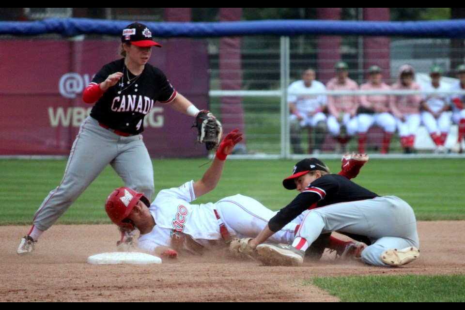 Canada's Madison Willan watches her teammate Mia Valcke tag out a sliding Maria Valenzuela of Mexico during the opening inning of their WBSC Women's Baseball World Cup game at Port Arthur Stadium on July 28.