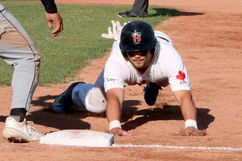 Thunder Bay's Jonah Sutton dives back safely into first on Saturday, July 8, 2023 against the Rochester Honkers. (Leith Dunick, tbnewswatch.com)