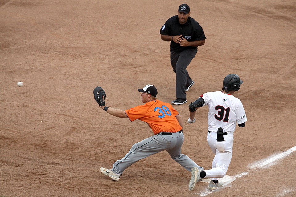 Thunder Bay's Thomas Cooper appears to beat the throw to the bag as Eau Claire 1B Gabe Richardson awaits the ball, on Monday, Aug. 5, 2024. Cooper was called out on the play. (Leith Dunick, tbnewswatch.com)