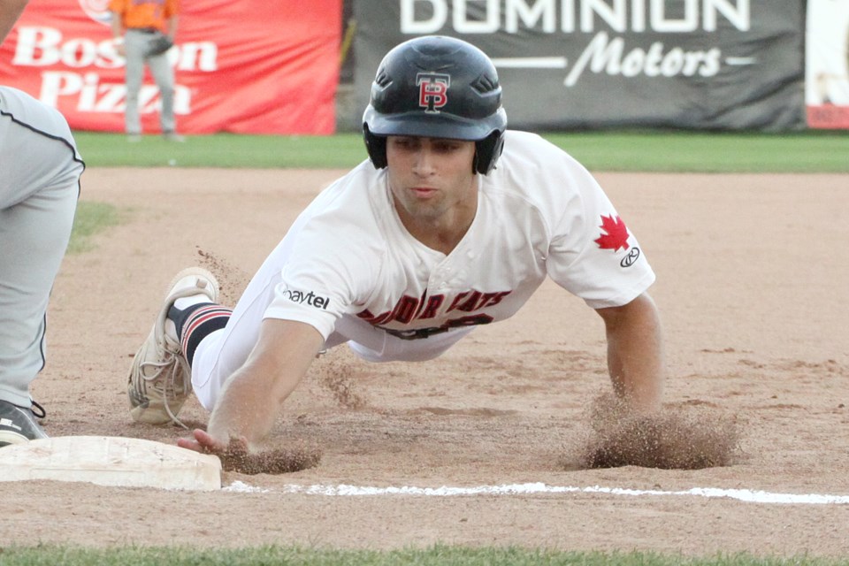 Nathanael Frederking slides back safely into first against the Eau Claire Express on Wednesday, Aug. 7, 2024. (Leith Dunick, tbnewswatch.com)