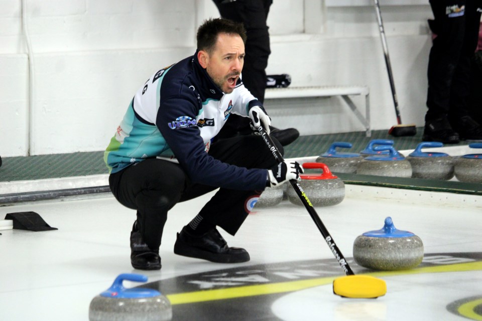 John Epping gives instructions to his team during a game against Gary Weiss at the Northern Ontario men's curling playdowns on Wednesday.