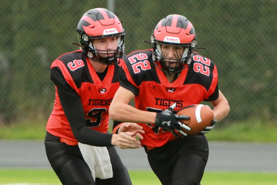 Westgate's Hudson Van Dyk (right) takes the handoff from quarterback Graham Deans on Tuesday, Oct. 24, 2023 in the high school junior quarterfinal match against Superior Collegiate. (Leith Dunick, tbnewswatch.com)