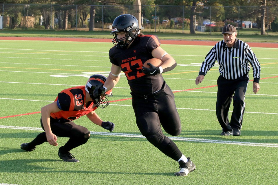 St. Ignatius running back Jayce Zaroski, seen avoiding a tackle by Koen Hurlbert, had 204 yards on the ground and scored a touchdown to help lead the Falcons to a 30-29 win over Westgate on Thursday, Oct. 10, 2024 at Fort William Stadium. (Leith Dunick, tbnewswatch.com)