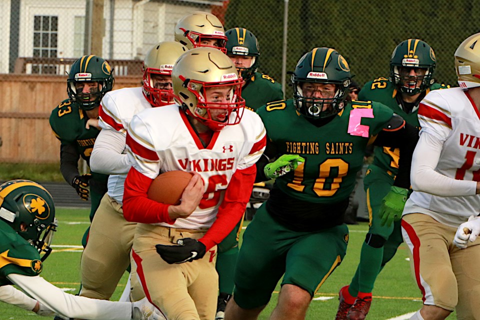 Hammarskjold's Gabriel Stieh with the carry on Friday, Oct. 27, 2023 against the St. Patrick Saints. He'd later score a 17-yard, game-winning touchdown. (Leith Dunick, tbnewswatch.com)