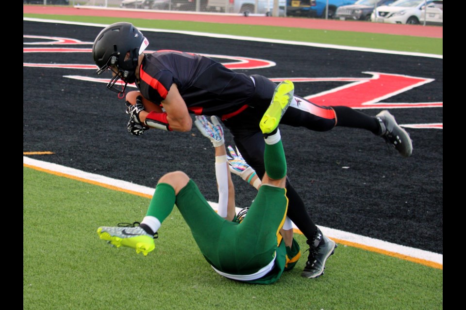 St. Ignatius Falcons wideout Aiden Palko makes a catch while getting tangled up with Anthony Scambuluri of the St. Patrick Fighting Saints on Sept. 20, 2024. 