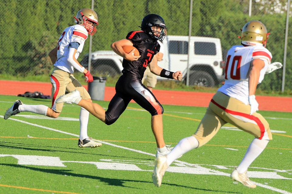 St. Ignatius quarterback Lucas Dupuis outraces Hammarskjold defenders Nicholas Baker-Patich (left) and Liam Lucas for a 91-yard touchdown on Friday, Sept. 27, 2024 at Fort William Stadium. (Leith Dunick, tbnewswatch.com)