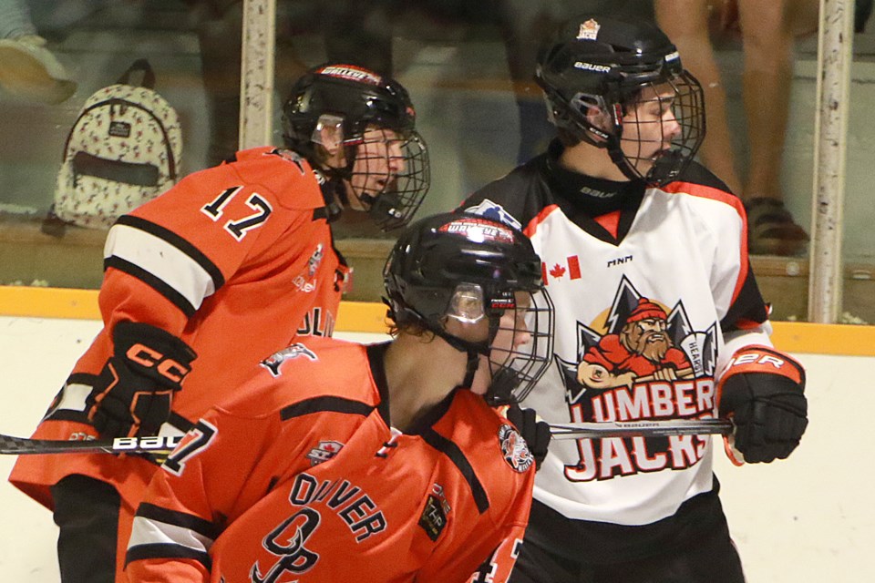 Action photo of Hearst Lumberjacks forward Cooper Moore (background) with Jett Mintenko (left) and Carter Poddubny (foreground) of the Kam River Fighting Walleye on Friday September 1st 2023