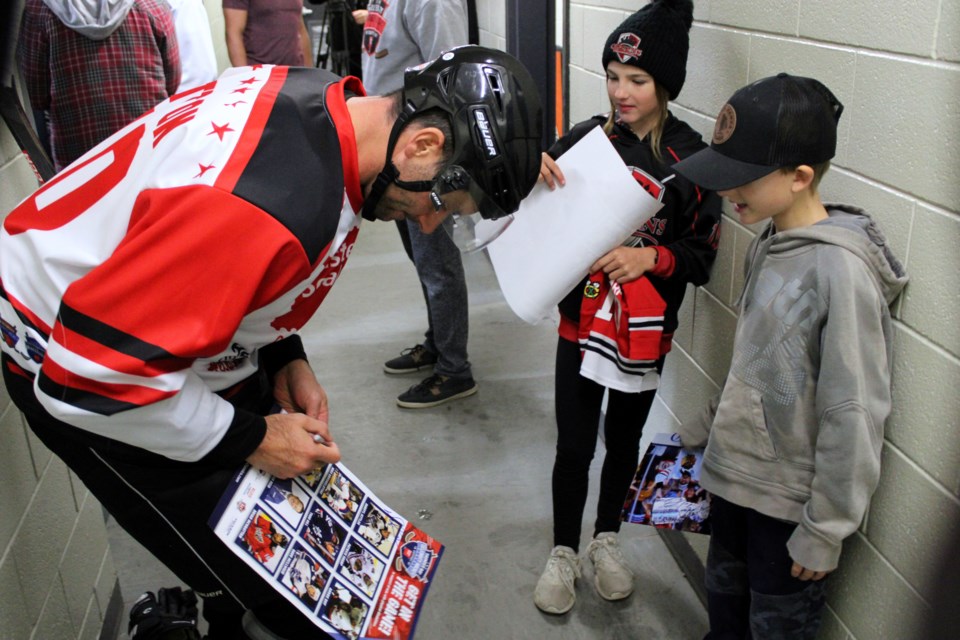 Carter Hutton signs an autograph during the the seventh annual Easter Seals Celebrity Hockey Classic.