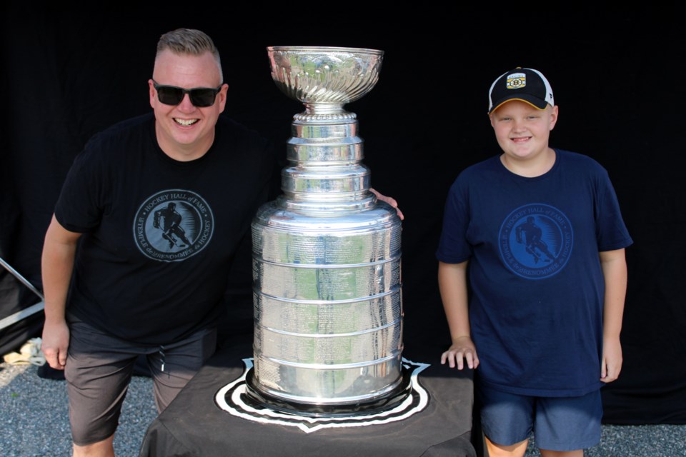 Jamie Einarson and his son Colten were all smiles as they posed with the Stanley Cup at Port Arthur Stadium on Sept. 11.