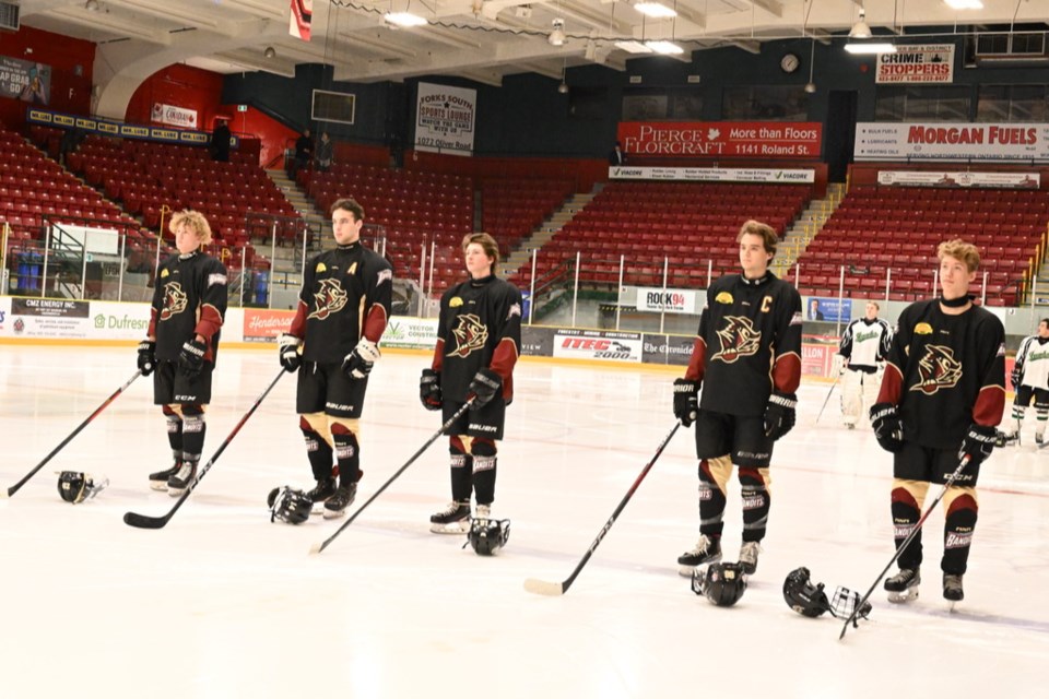 Bandits Captain Darian Smith (second from the right) lined up with teammates on the blue line of the Fort William Gardens