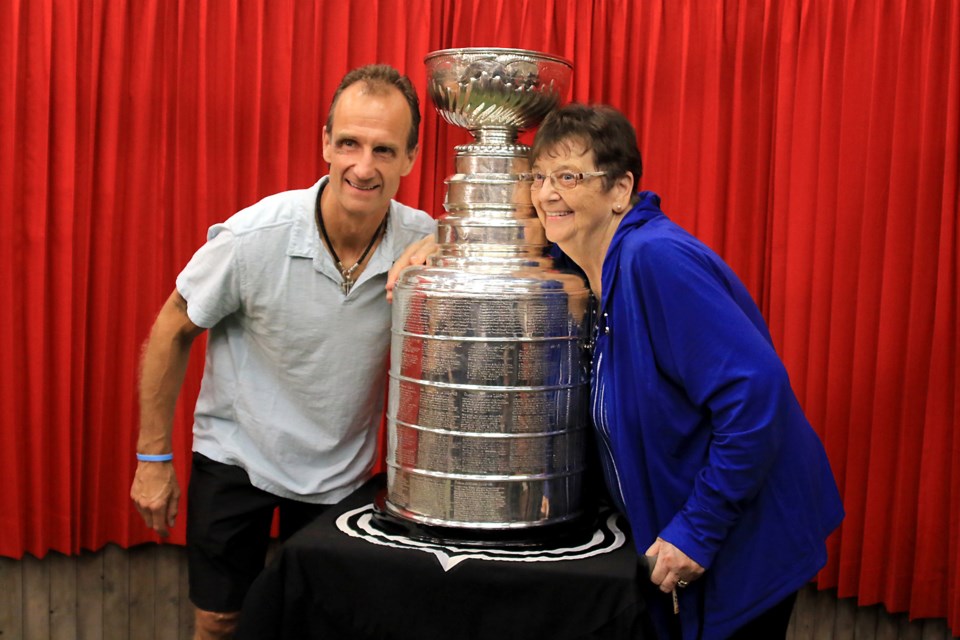 Jamie Kompon and his mother, Sandra, pose with the Stanley Cup on Wednesday, Sept. 11, 2024 at the Northwestern Ontario Sports Hall of Fame. (Leith Dunick, tbnewswatch.com)