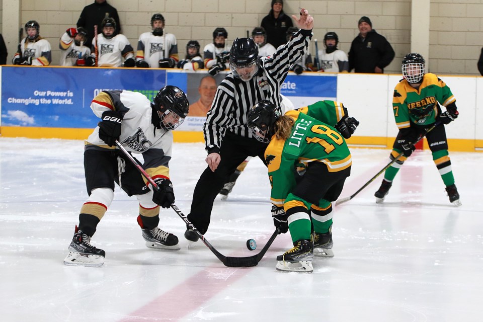 Ethan Belda (left), of the U13 KC Golden Knights and Katelyn Little, of the Neebing Hawks, take the ceremonial faceoff on Thursday, Jan. 19, 2023 to kick off the 30th annual Robin's Minor Hockey Classic at the Neebing Arena. (Leith Dunick, tbnewswatch.com)