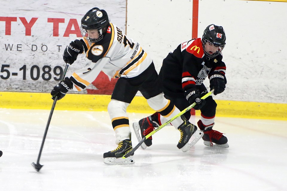 Current River's Peter Sims (left) skates past KC Devils player Nathan Greenwald on Thursday, Jan. 18, 2024 at the Current River Arena. (Leith Dunick, tbnewswatch.com)