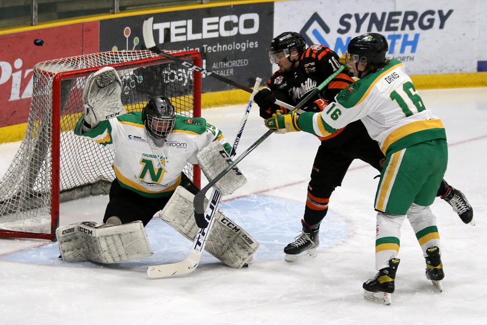 Kam River's Dayton Clarke (centre), who later scored the overtime winner, battles  in front of Thunder Bay North Stars goaltender Jordan Smith and defenceman Zach Davis on Monday, April 11, 2022 at Fort William Gardens. (Leith Dunick, tbnewswatch.com)