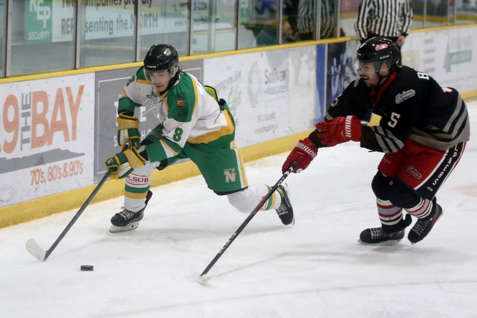 Thunder Bay's Anthony Kuzenko looks for an angle, with Fort Frances' Brandon Rossetti closing in on Friday, Dec. 17, 2021 at Fort William Gardens. (Leith Dunick, tbnewswatch.com)