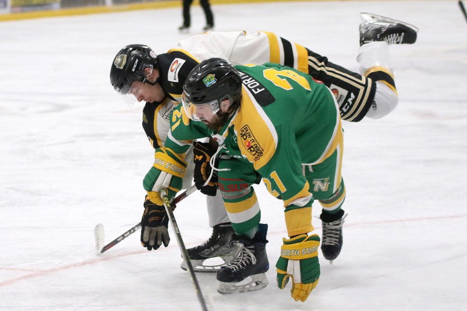 Thunder Bay's Bradley Fortier tangles with Red Lake's Mathieu Harrold on Thursday, Feb. 17, 2022 at Fort William Gardens. (Leith Dunick, tbnewswatch.com)