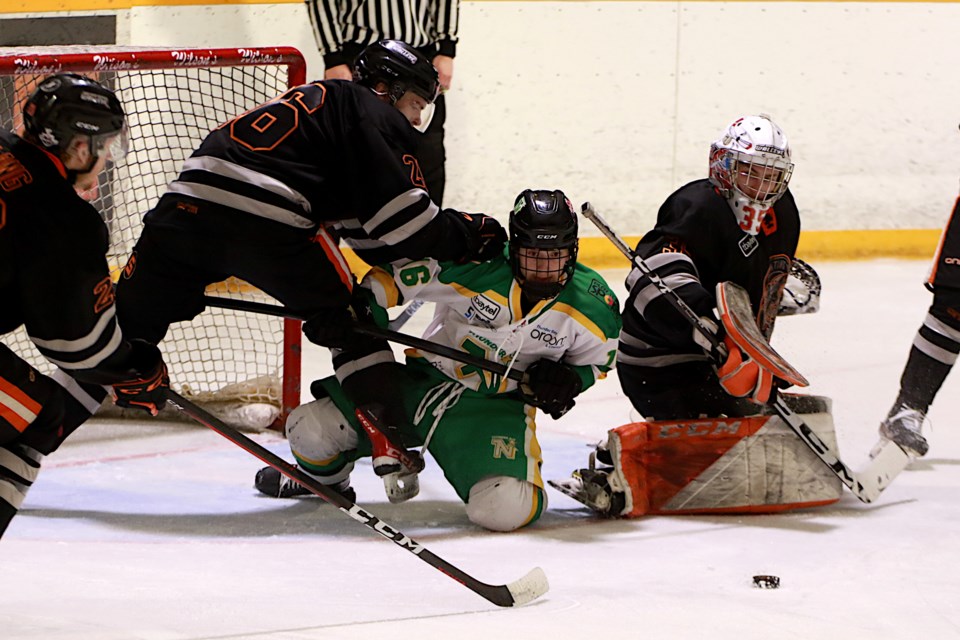 Thunder Bay's Evan Lachimea seeks out the puck on Sunday, April 23, 2023, nestled between Kam River defenceman Jack Cook (left) and goaltender Eric Vanska. (Leith Dunick, tbnewswatch.com)