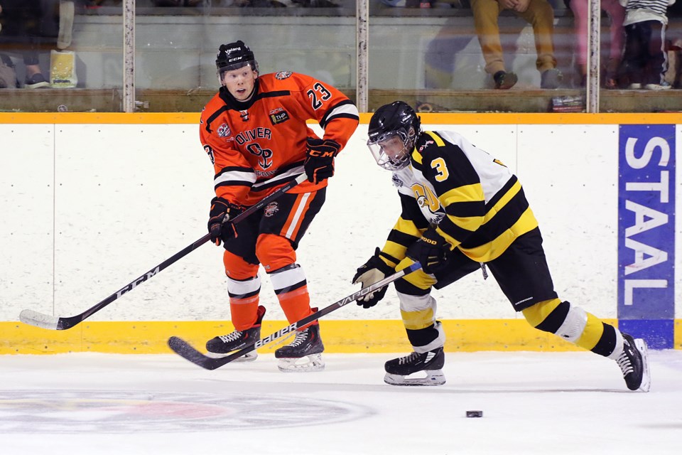 Kam River's Ethan Lang (23) and Soo's Joey Woldt (3) chase down a loose puck on Friday, Sept. 2, 2022 at the Norwest Arena in Oliver Paipoonge. (Leith Dunick, tbnewswatch.com)