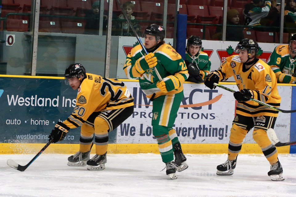 Thunder Bay's R.J. Dickie, (centre) scored the overtime winner on Saturday, Feb. 11, 2023 against the Red Lake Miners. He's seen here between Red Lake's Dayvan Bull (20) and Riley See. (Leith Dunick, tbnewswatch.com)